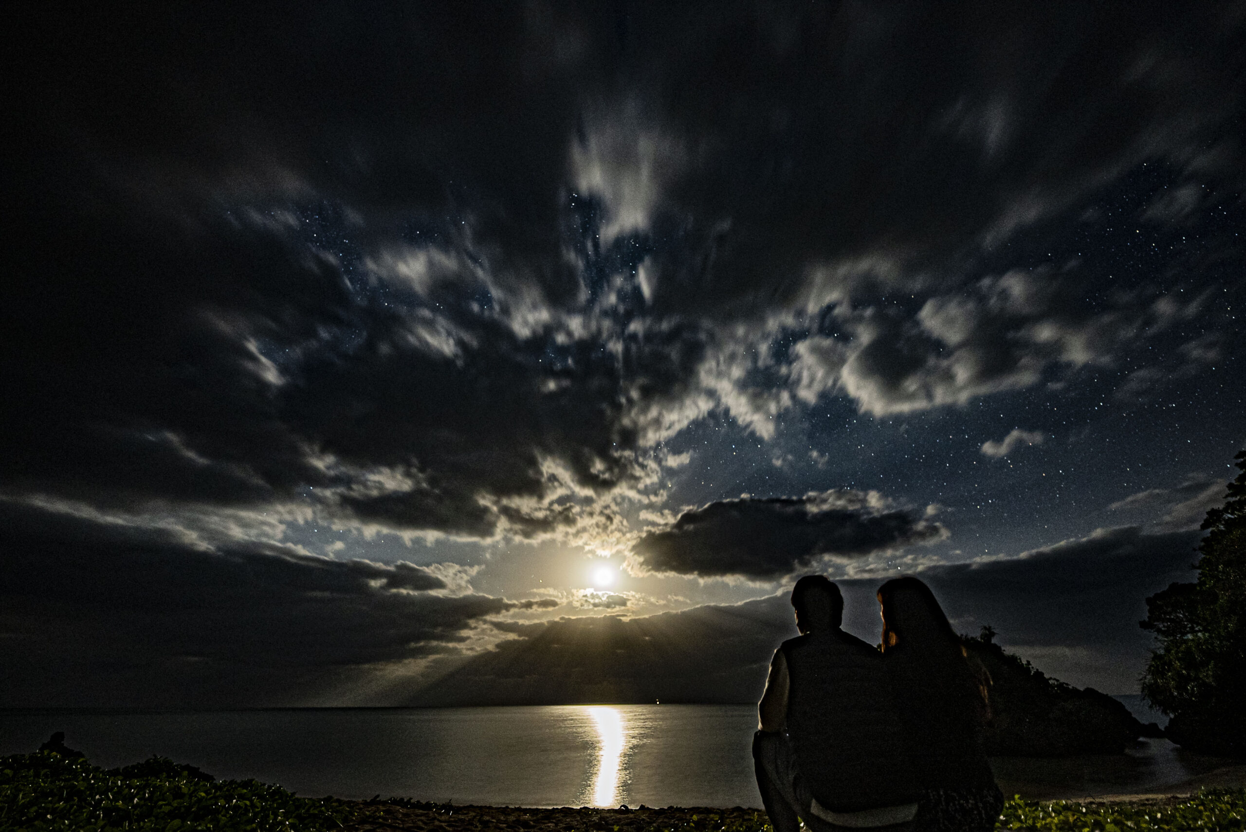 Couple enjoying seaside moonlight and ocean view at Nagareboshi no Oka, Ishigaki Island
