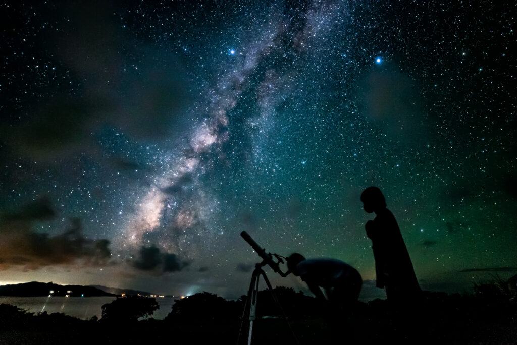 Milky Way galaxy with telescope and person silhouette at Nagareboshi no Oka stargazing spot, Ishigaki Island
