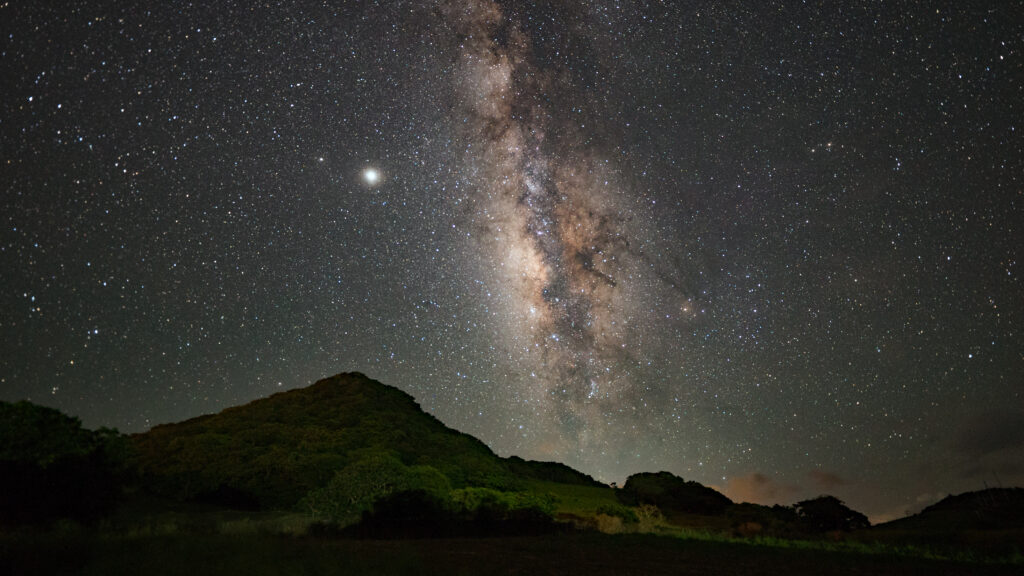 Milky Way rising over a green hilltop at Nagareboshi no Oka, Ishigaki Island