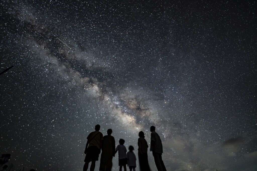 Family silhouette milky way at Nagareboshi no Oka stargazing spot, Ishigaki Island